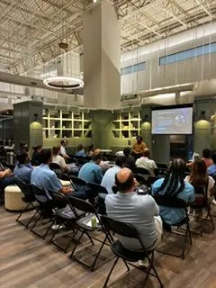 Audience seated theater-style at a corporate training event