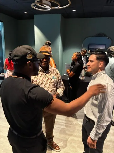 Professionals standing and talking at a networking meeting
