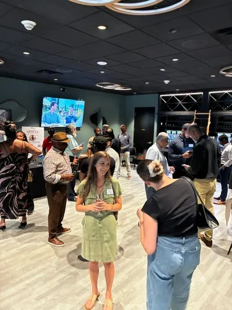 Attendees standing and mingling at a busy networking event