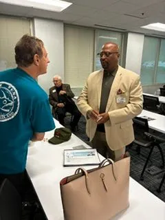 Two attendees in friendly conversation at an office networking event