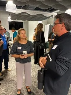 Man and woman holding drinks during a networking conversation