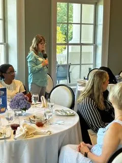 Professionals seated at tables during a networking event.