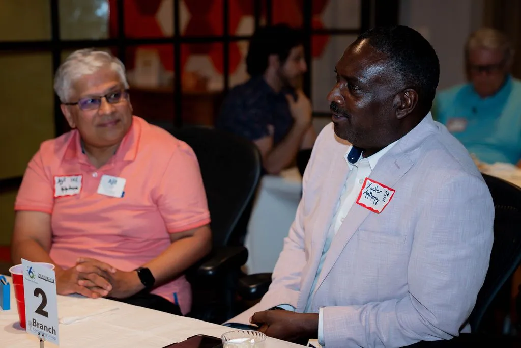 Two professionals talking during a networking event